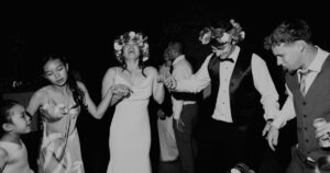 A bride and groom dance with guests at their wedding reception in Mesa.