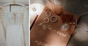 A wedding dress hangs next to a photo of a wedding invitation and wedding rings.