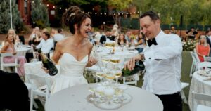 A bride and groom pose at their Sedona wedding reception at Amara Resort.