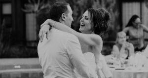 A bride and groom pose at their Sedona wedding reception at Amara Resort.