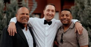 A groom and guests pose at a wedding reception in Sedona, Arizona.