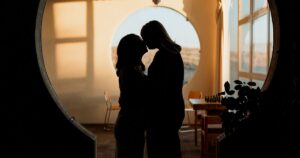 A couple poses indoors at Arcosanti, one of the 5 best summer engagement session locations in Arizona