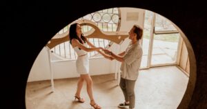 A couple poses indoors at Arcosanti, one of the 5 best summer engagement session locations in Arizona