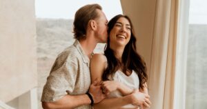 A couple poses indoors at Arcosanti, one of the 5 best summer engagement session locations in Arizona