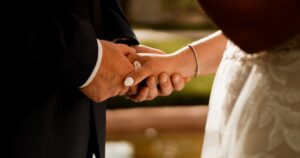 A bride and groom hold hands at their Tucson wedding at Wildhorse Ranch.