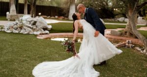 A bride and groom pose at their Tucson wedding at Wildhorse ranch.