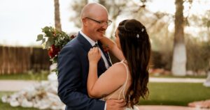 A bride and groom pose at their Tucson wedding at Wildhorse ranch.