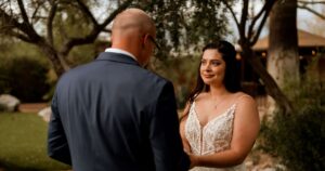 A bride and groom pose at their Tucson wedding at Wildhorse ranch.