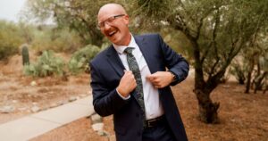 A groom poses at his Tucson wedding at Wildhorse Ranch. 