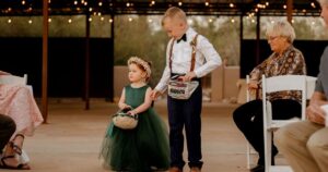 A flower girl and ring bearer pose at a Tucson wedding at Wildhorse ranch.