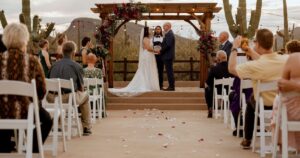 A bride and groom pose at their Tucson wedding at Wildhorse ranch.