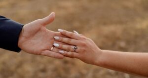 A bride and groom hold hands at their Tucson wedding at Wildhorse ranch.