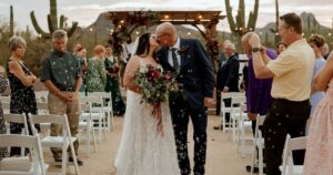 A bride and groom pose at their Tucson wedding at Wildhorse ranch.