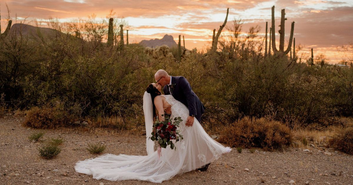 A bride and groom pose at their Tucson wedding at Wildhorse ranch.