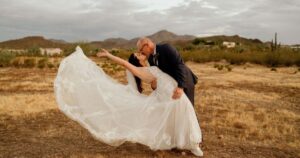 A bride and groom pose at their Tucson wedding at Wildhorse ranch.