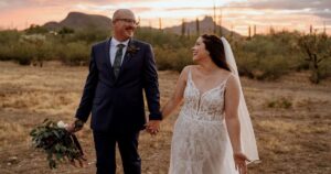 A bride and groom pose at their Tucson wedding at Wildhorse ranch.