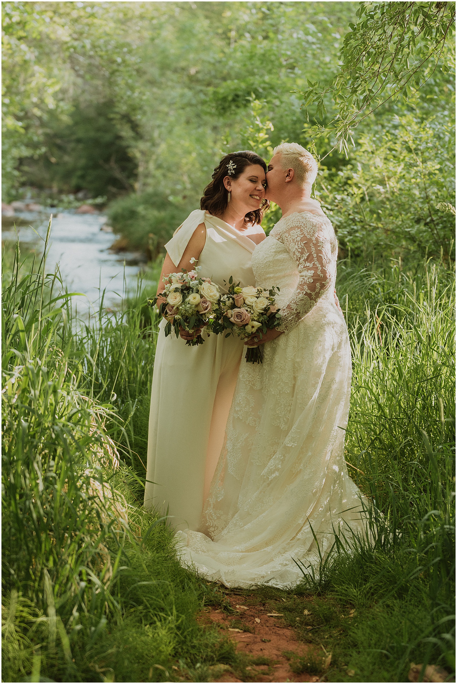 Two brides pose on a wooded path at the Creekside Inn Sedona.