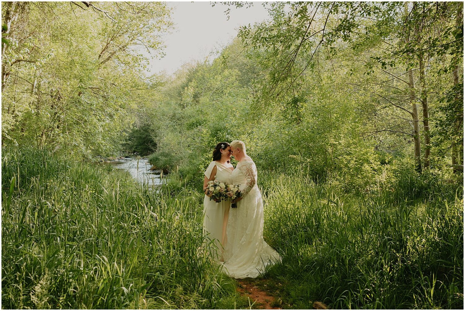 Two brides pose for an Arizona wedding photographer at the Creekside Inn Sedona.