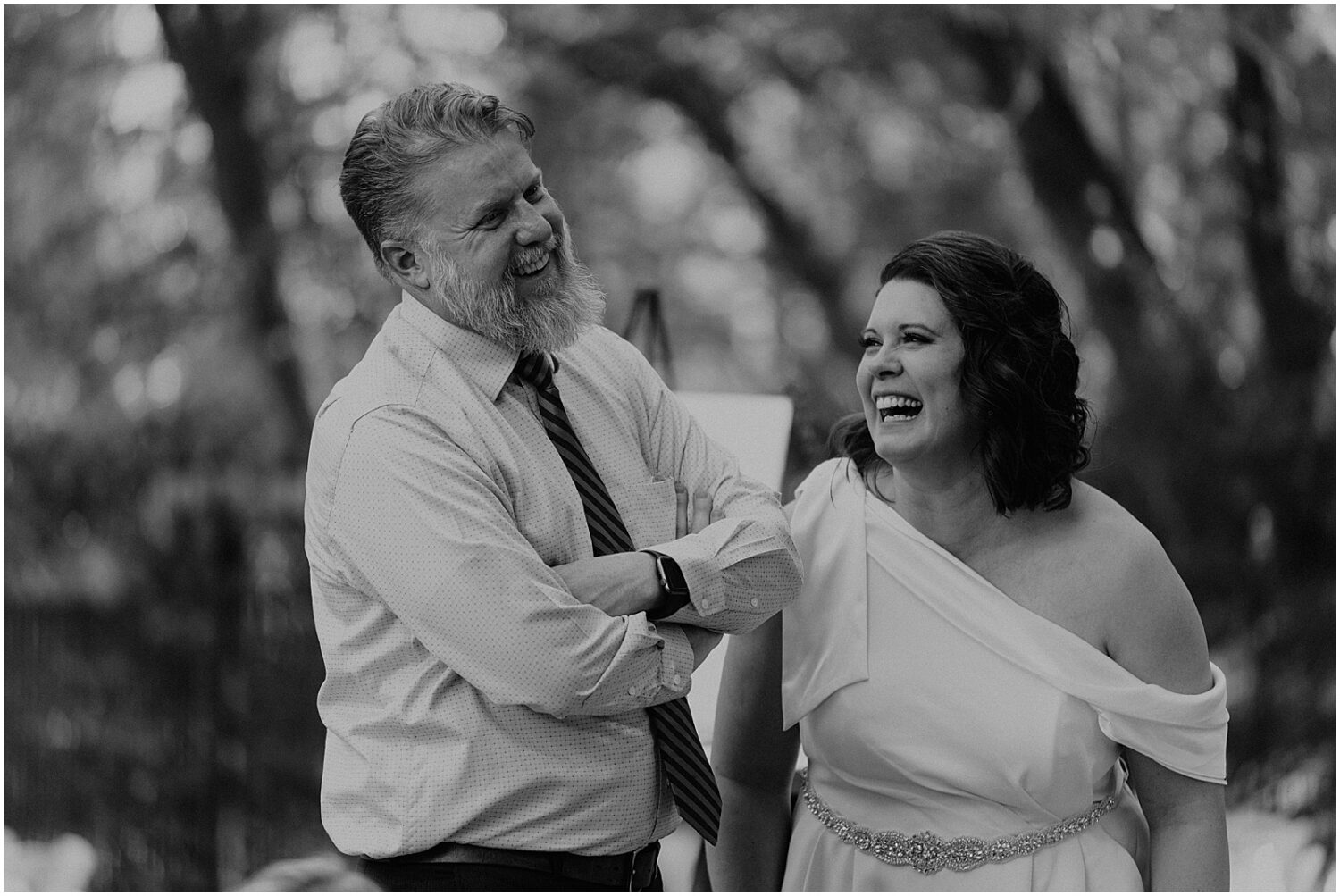 A bride laughs with her father.