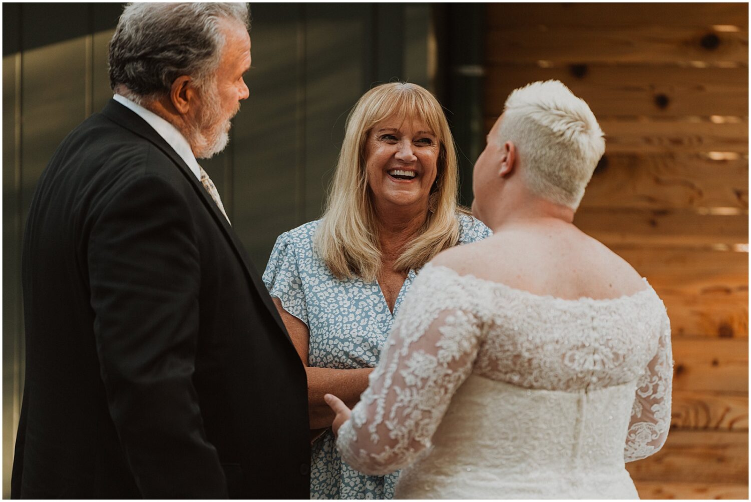 A bride laughs with her mother.