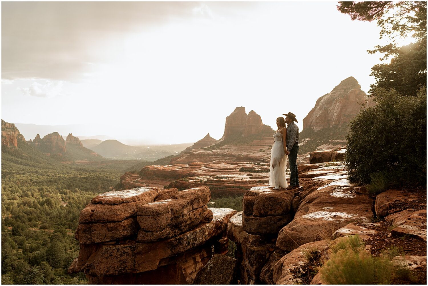 A couple looks out at Sedona from a lookout.