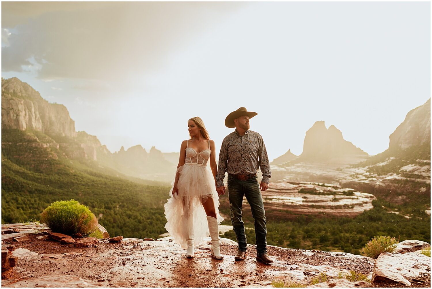 A man and woman hold hands on Merry Go Round Rock for a Sedona engagement session.