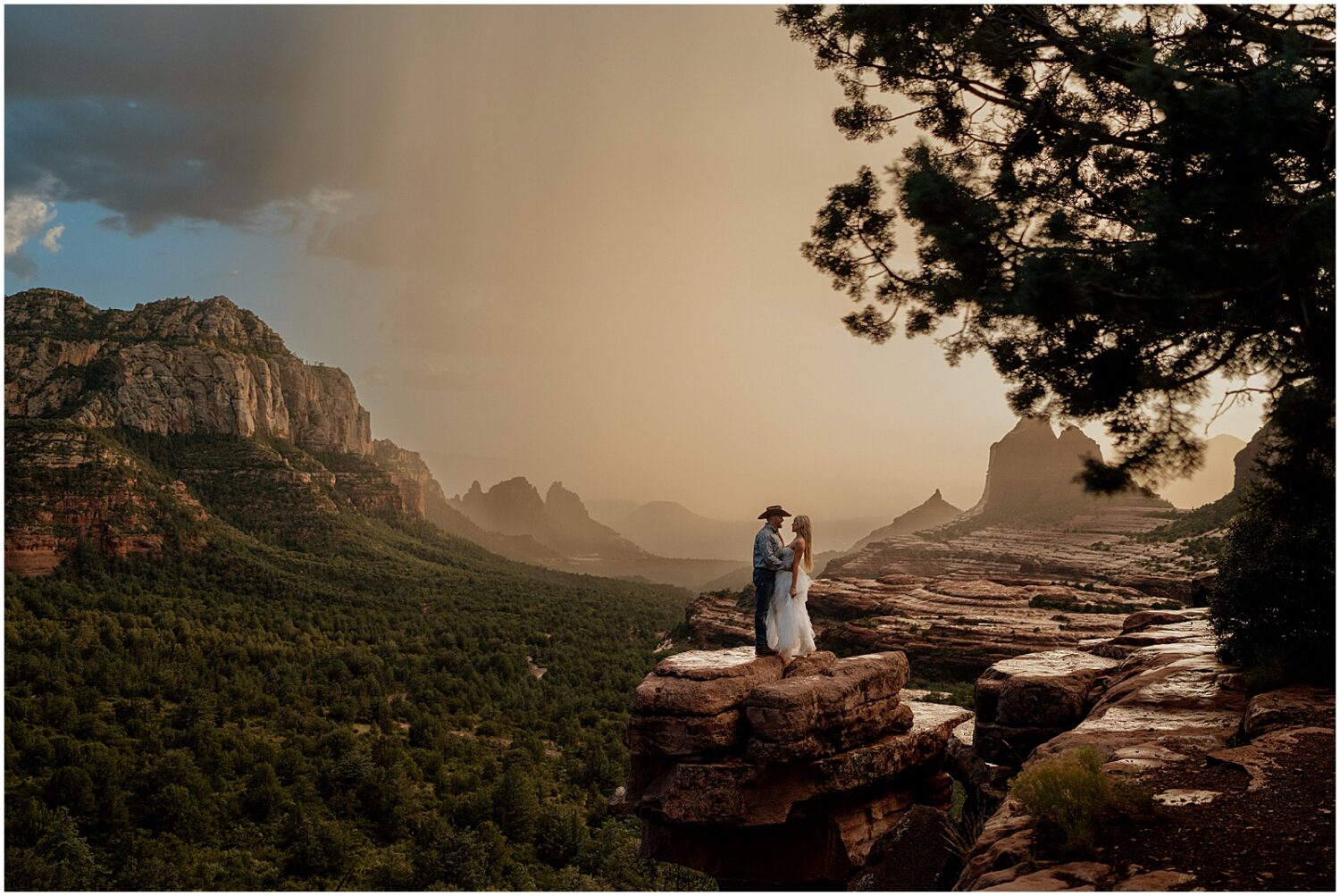 A storm rolls towards Sedona behind an engaged couple.