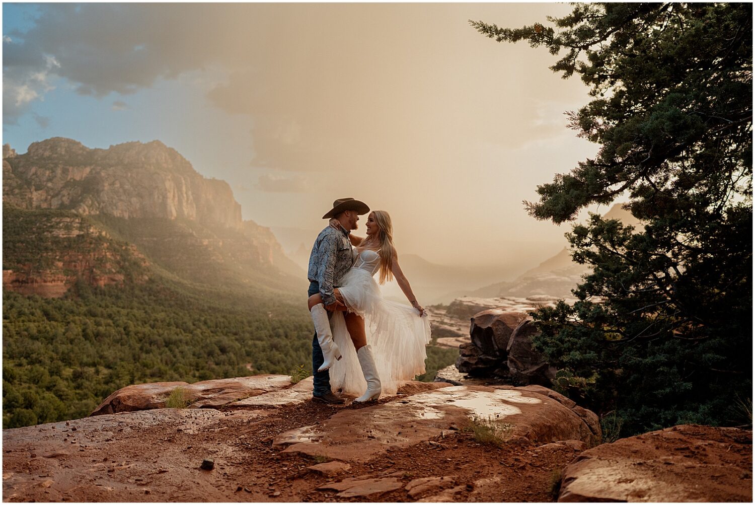 A man and woman pose for Sedona engagement photos before a desert storm.