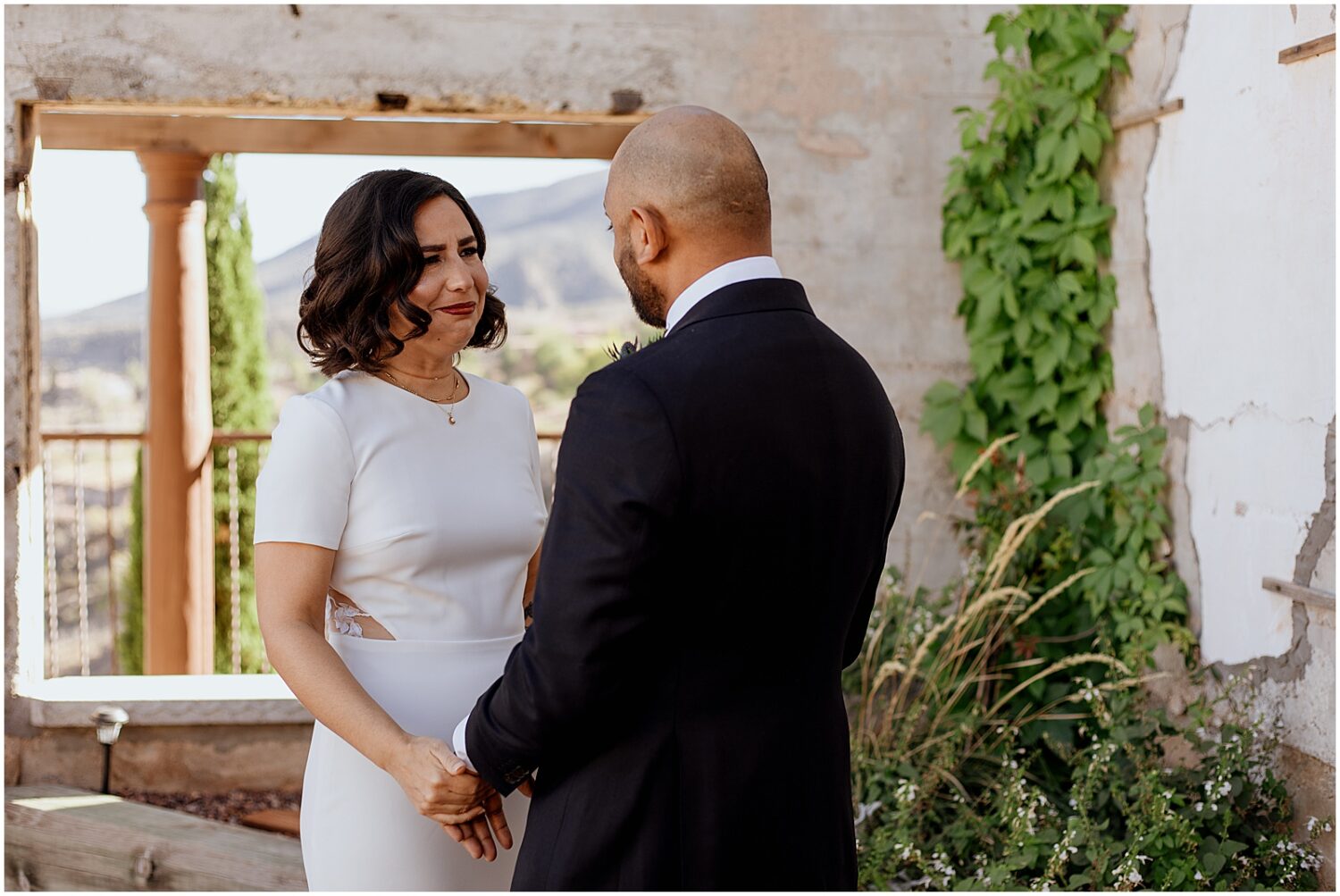 A bride and groom hold hands on the rooftop of the Little Daisy Jerome.