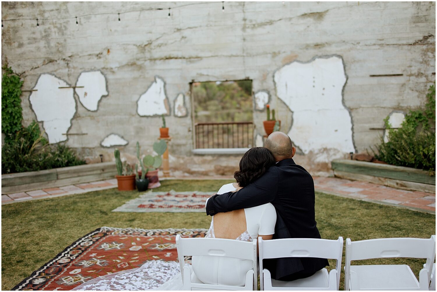 A bride and groom cuddle after their rooftop wedding ceremony in Jerome.