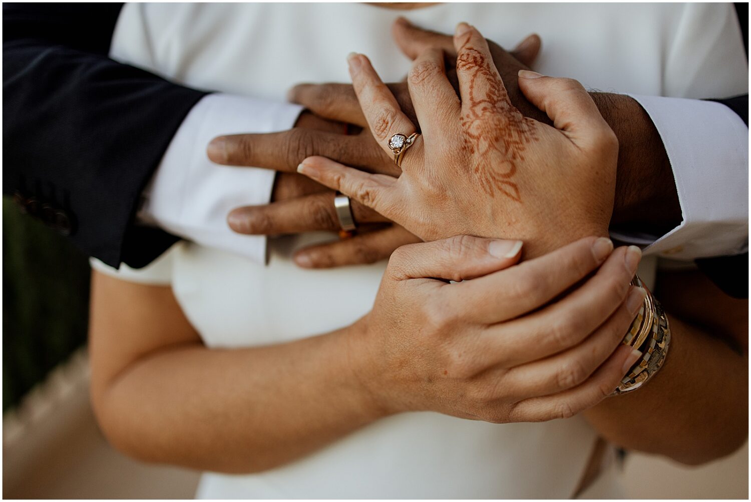 A groom wraps his arms around a bride.