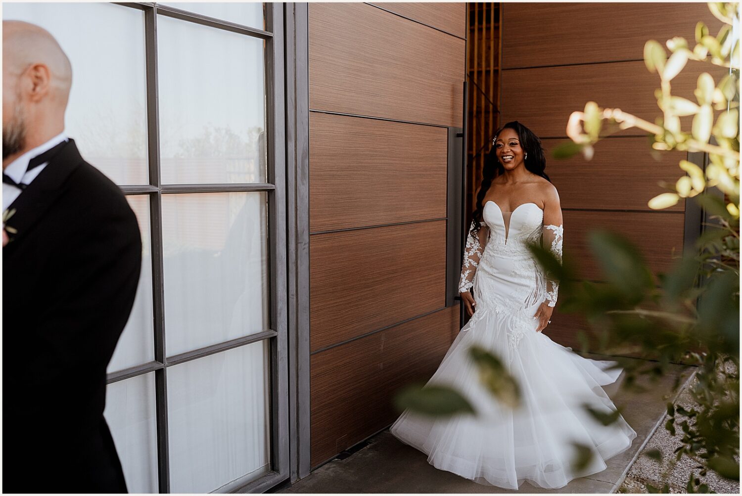 A bride approaches a groom for a first look.