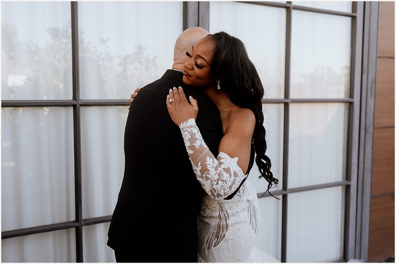 A bride and groom hug during their first look at The Paseo.
