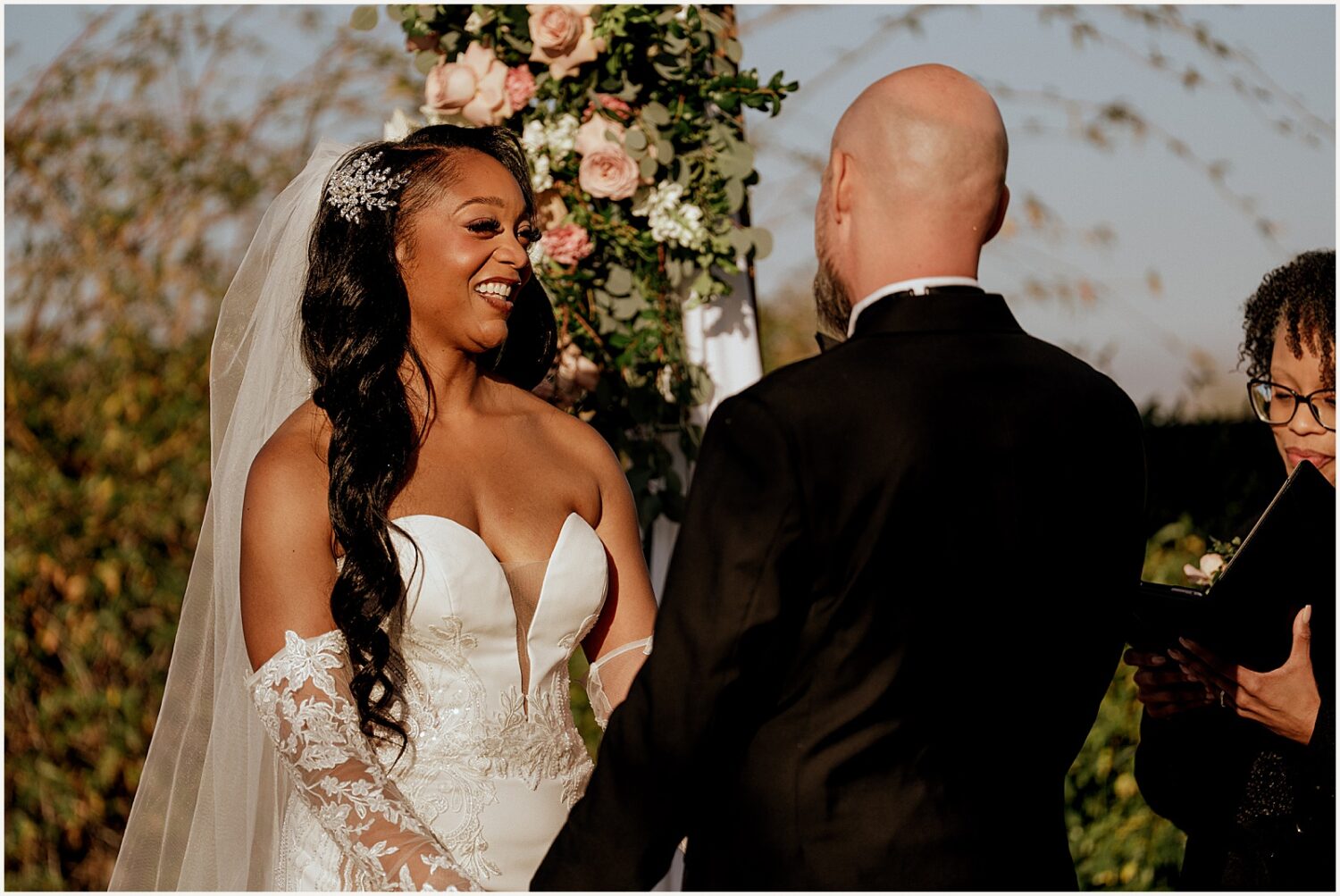 A bride and groom hold hands during an outdoor wedding ceremony in Apache Junction.
