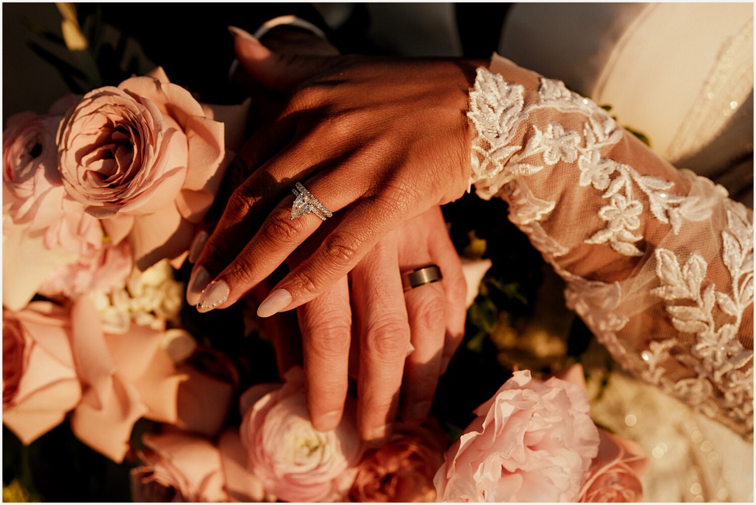 A bride rests her hand on a groom's.