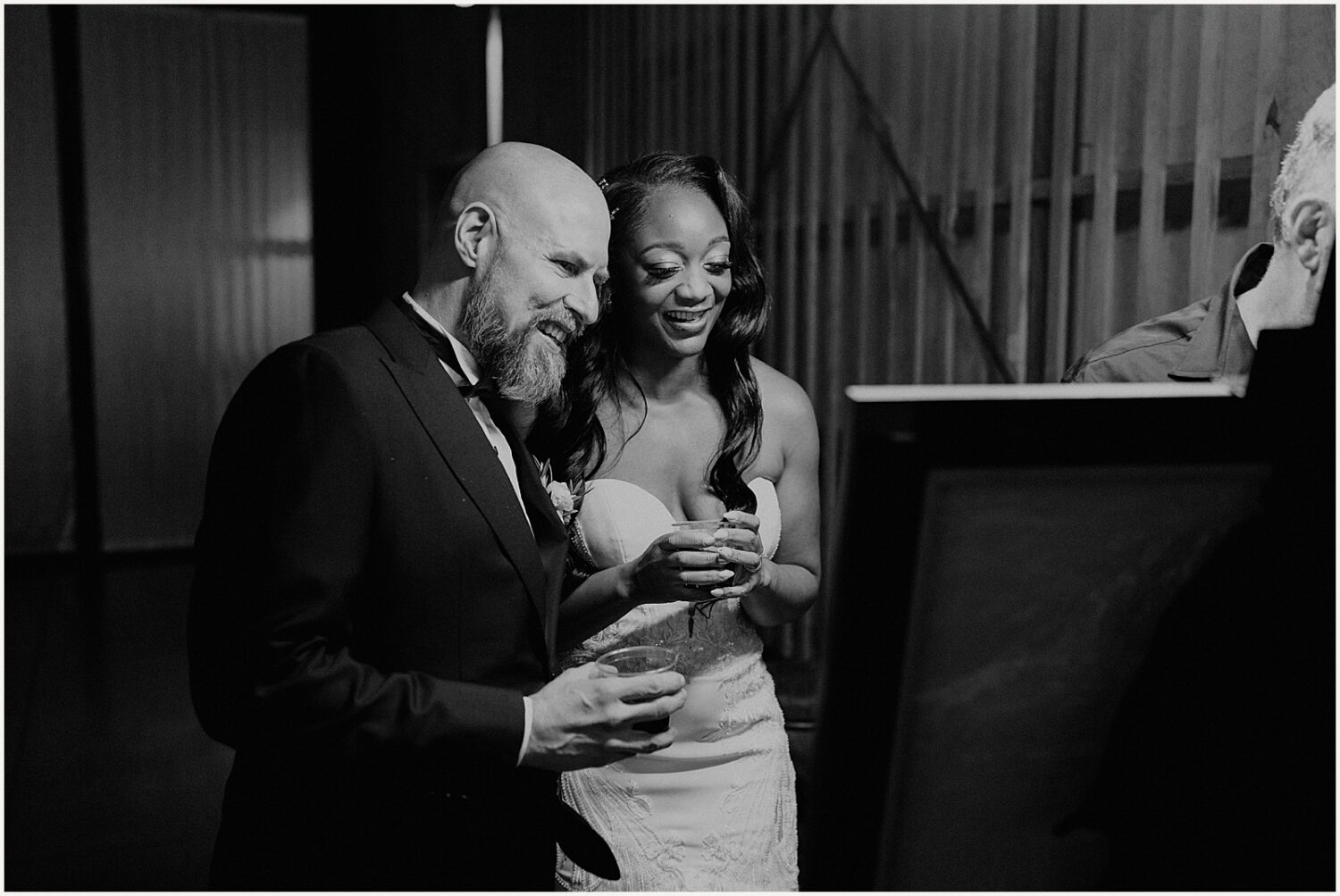 A bride and groom enter a wedding reception.