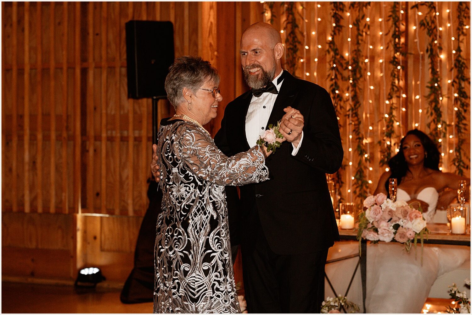 A groom dances with his mother.