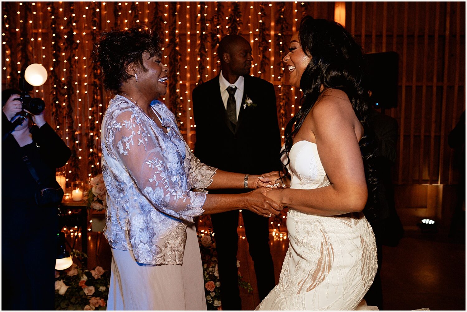 A bride dances with a family member.