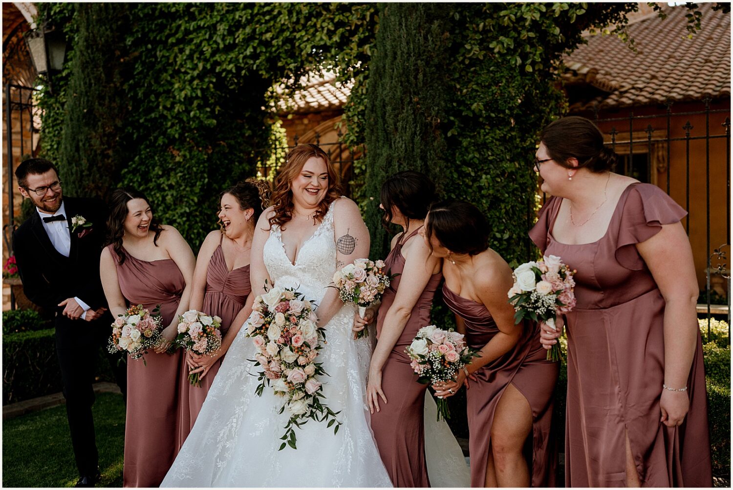 A bride and her bridesmaids walk forward laughing.