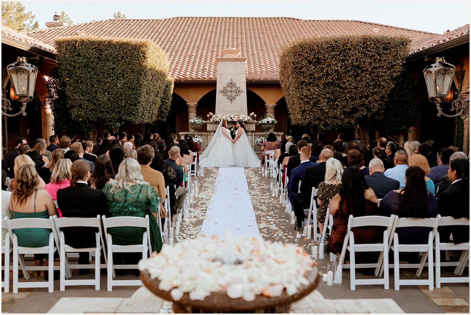 Two brides get married in the courtyard of Villa Siena Arizona.