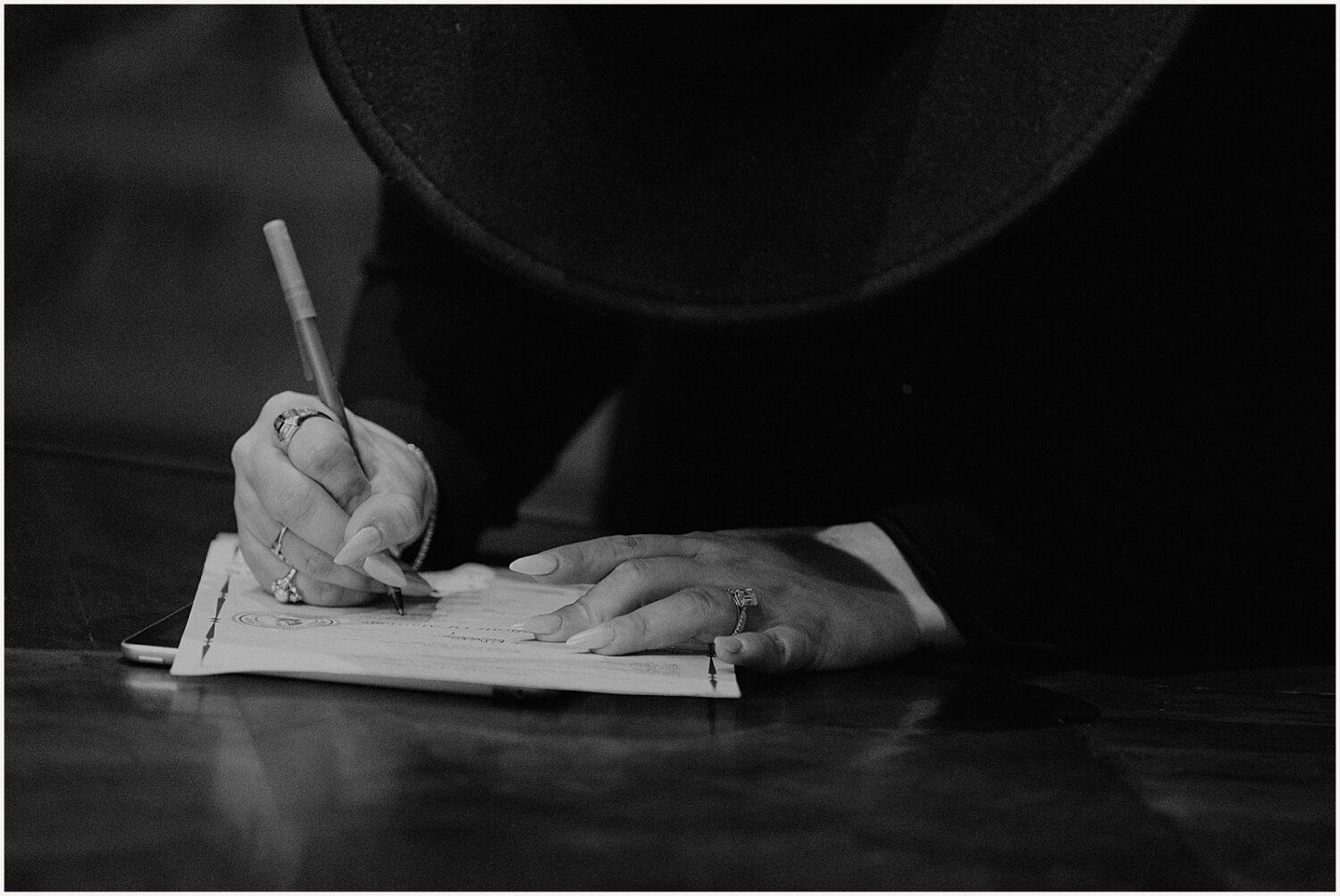 A wedding officiant signs an Arizona wedding license.