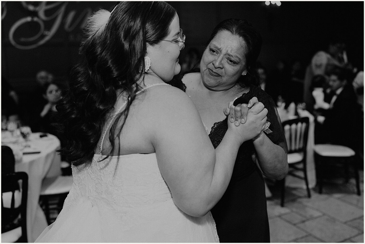 A bride dances with her mother.