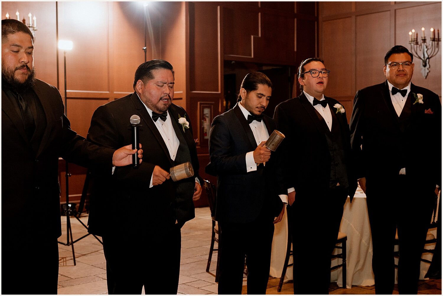 Three men sing.