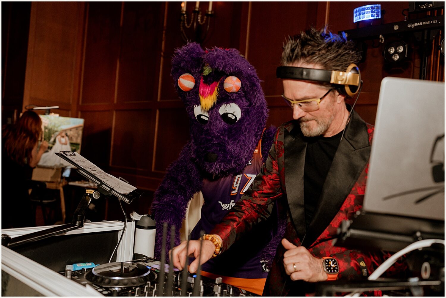 Scorch stands beside a wedding dj.