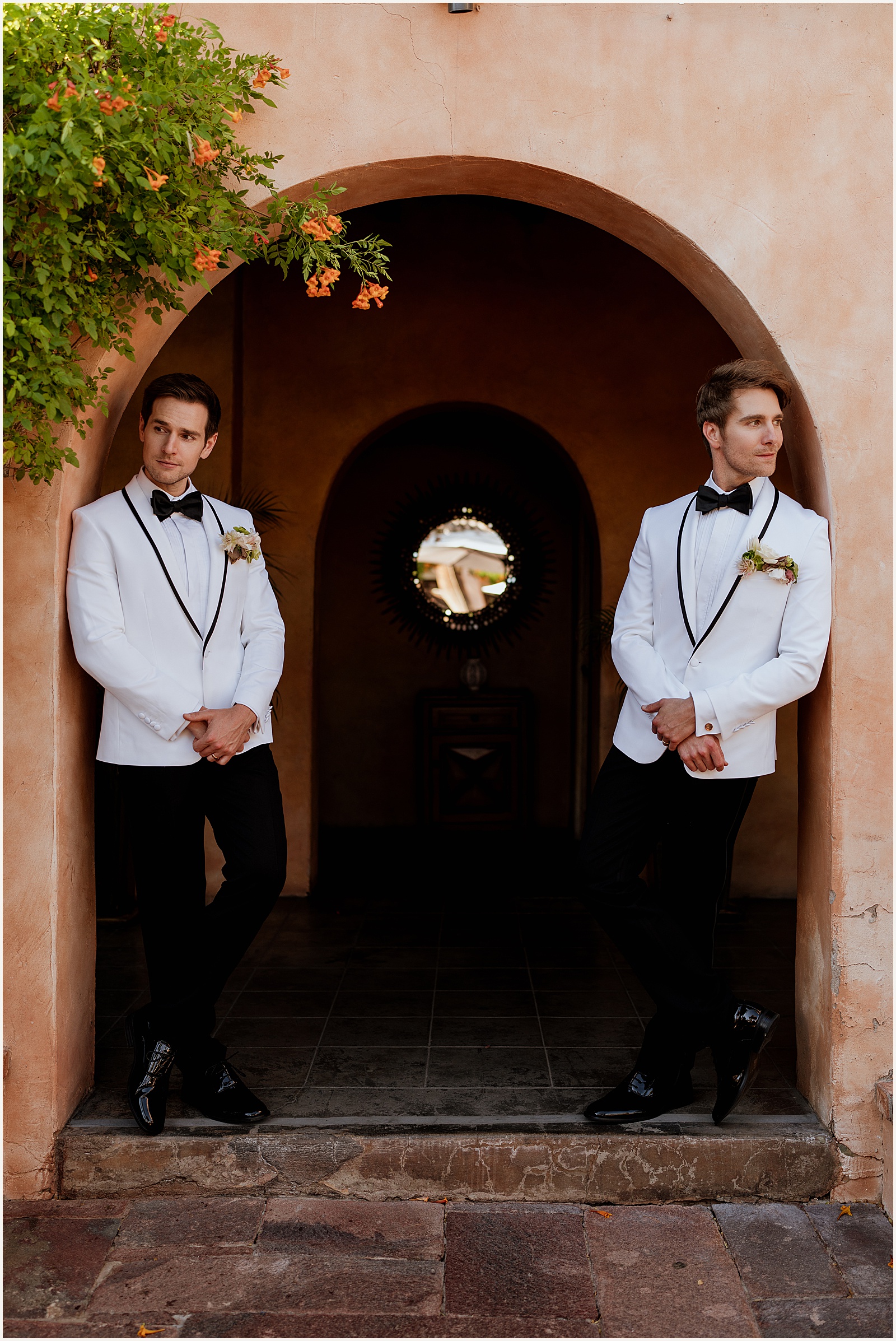 Two grooms lean against a doorway at the Royal Palms Arizona.