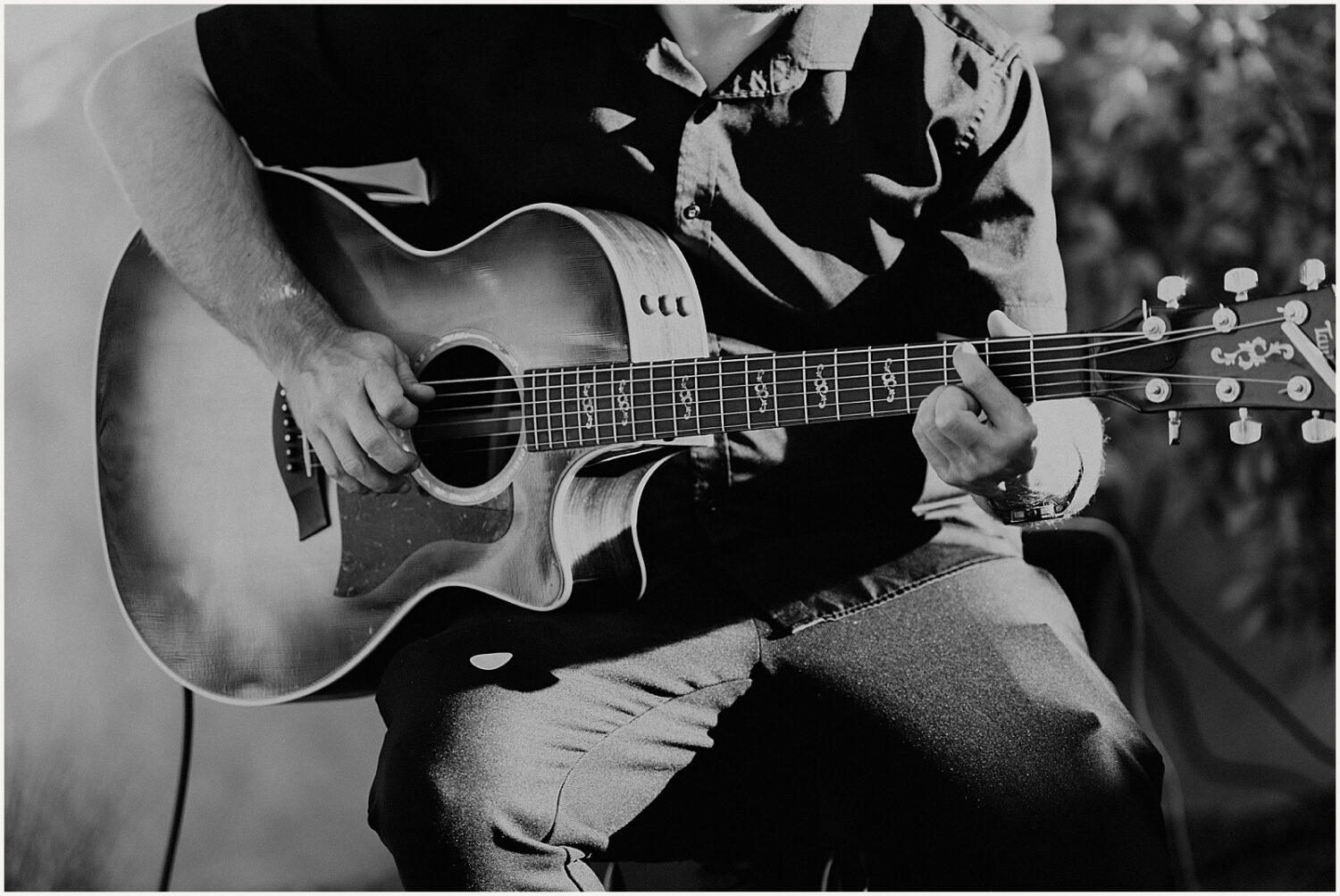 A guitar player plays at a wedding ceremony.