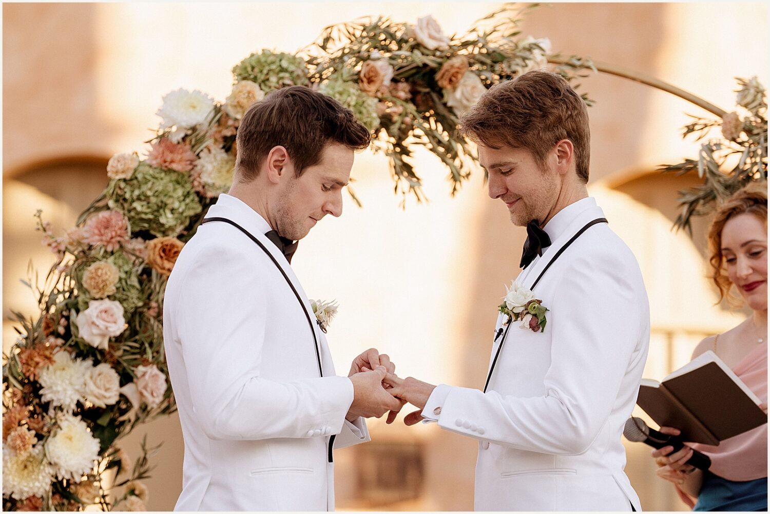 Two grooms exchange rings.