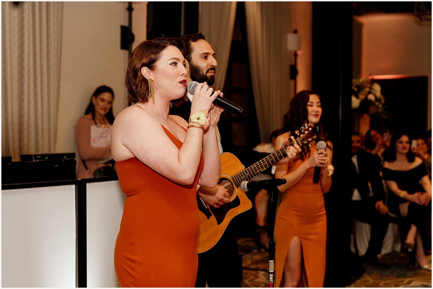 A woman sings into a microphone.