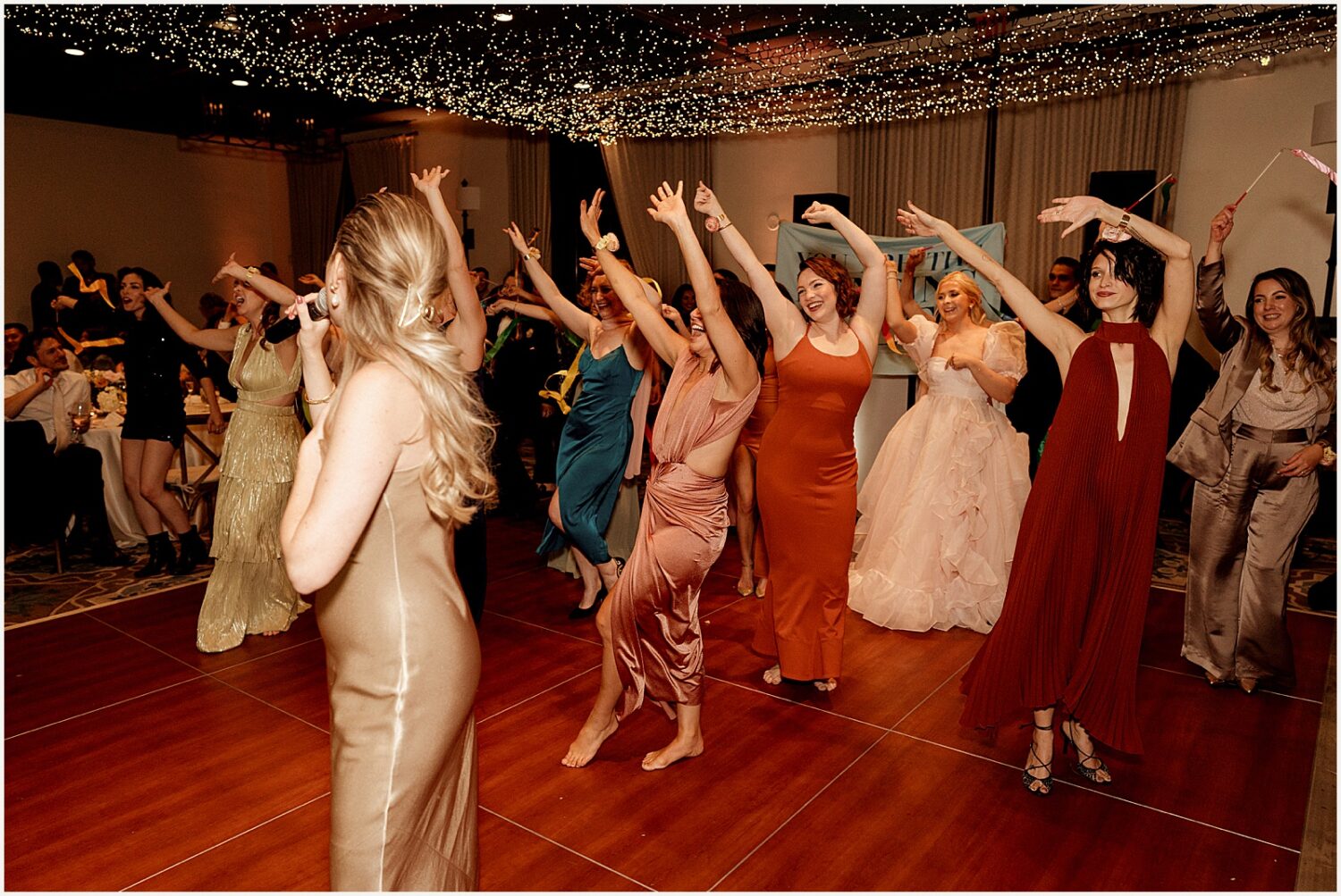 Wedding guests do a line dance.