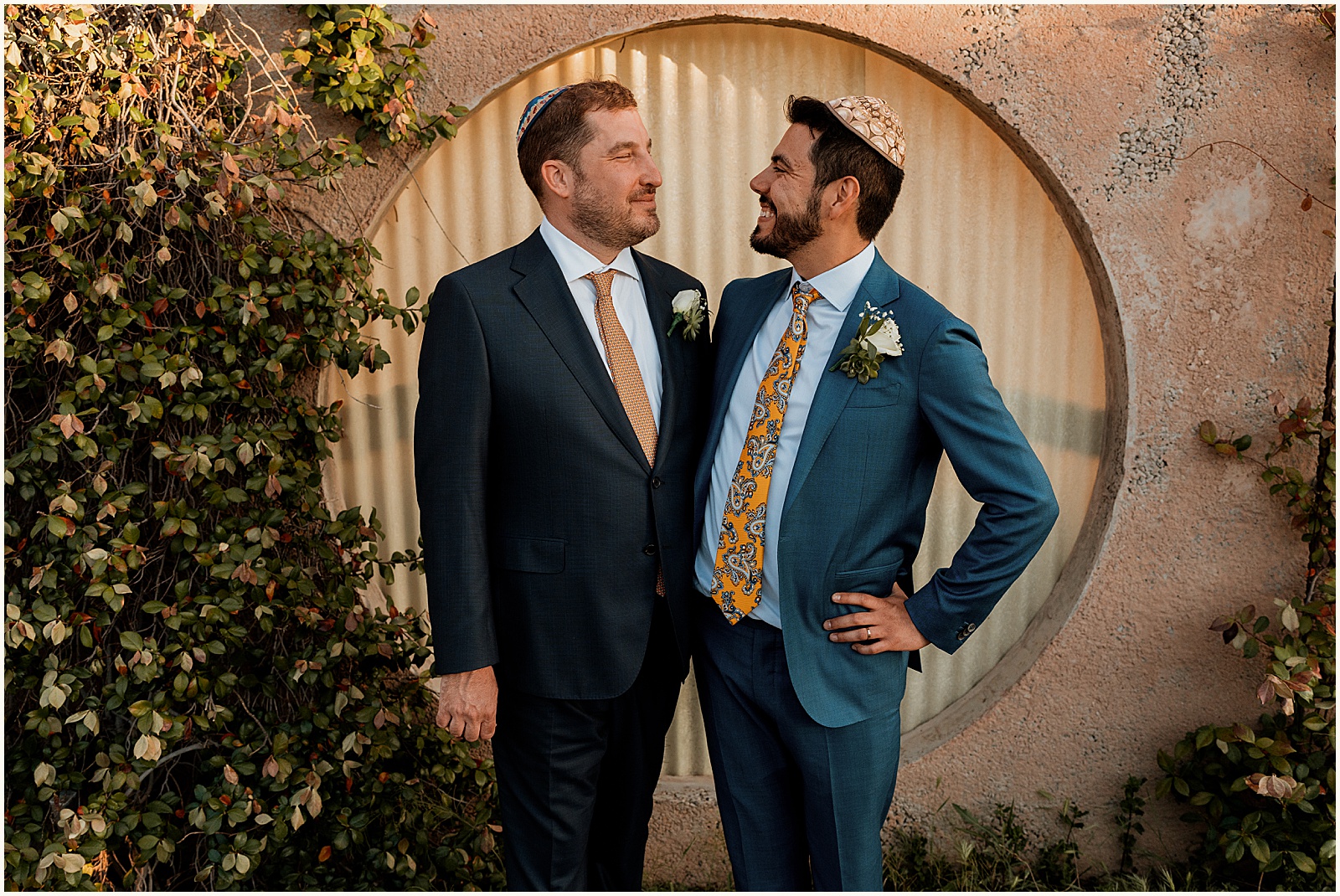Two grooms stand side by side in Jewish wedding photography.